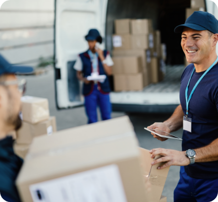 happy manual worker using touchpad while communicating with his coworker organizing package delivery